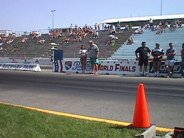 Fans and racers on the drag strip starting line during the World Finals